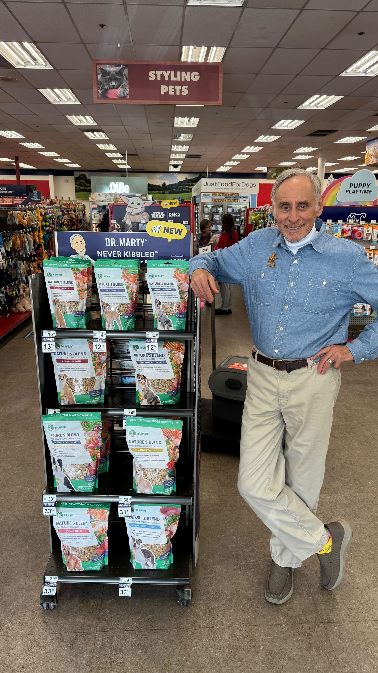 Dr. Marty Goldstein next to a Dr. Marty Pets retail display in store