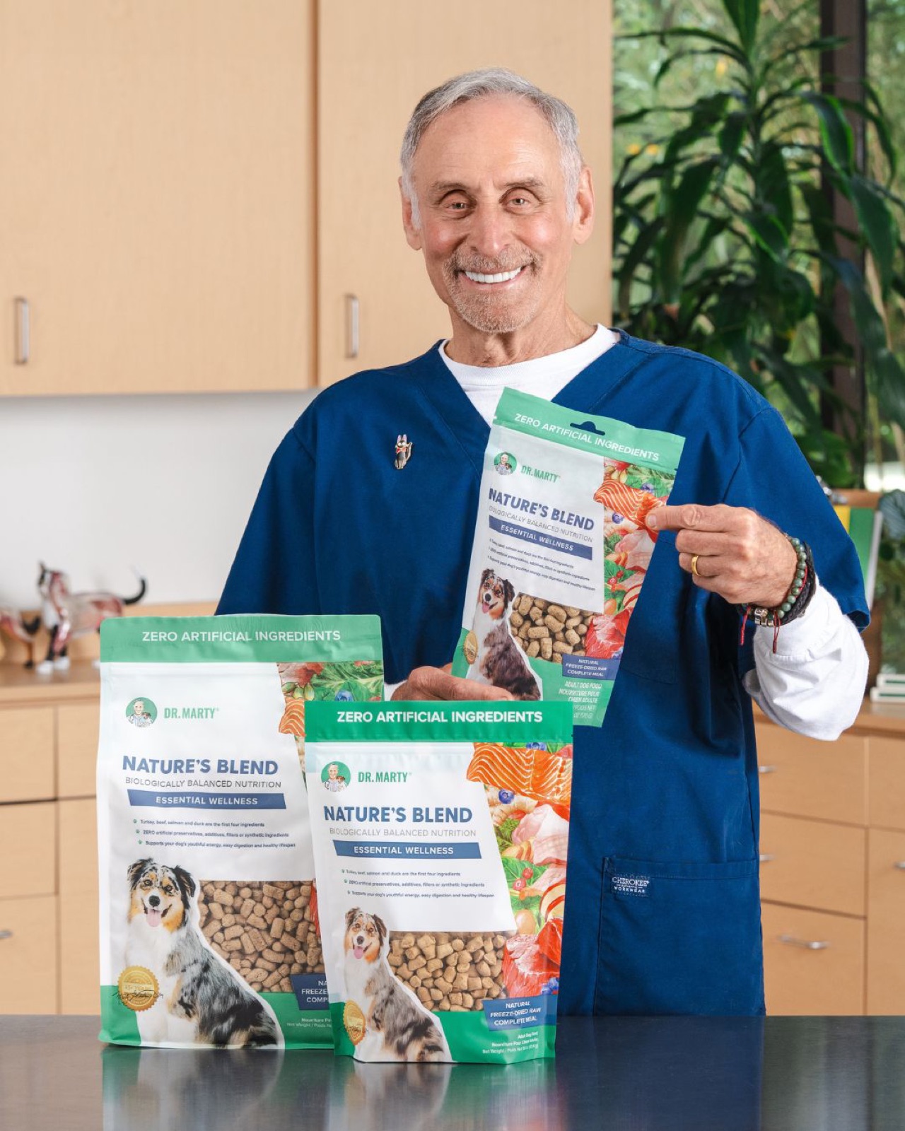 Dr. Marty Goldstein in scrubs holding three Nature's Blend pouches
